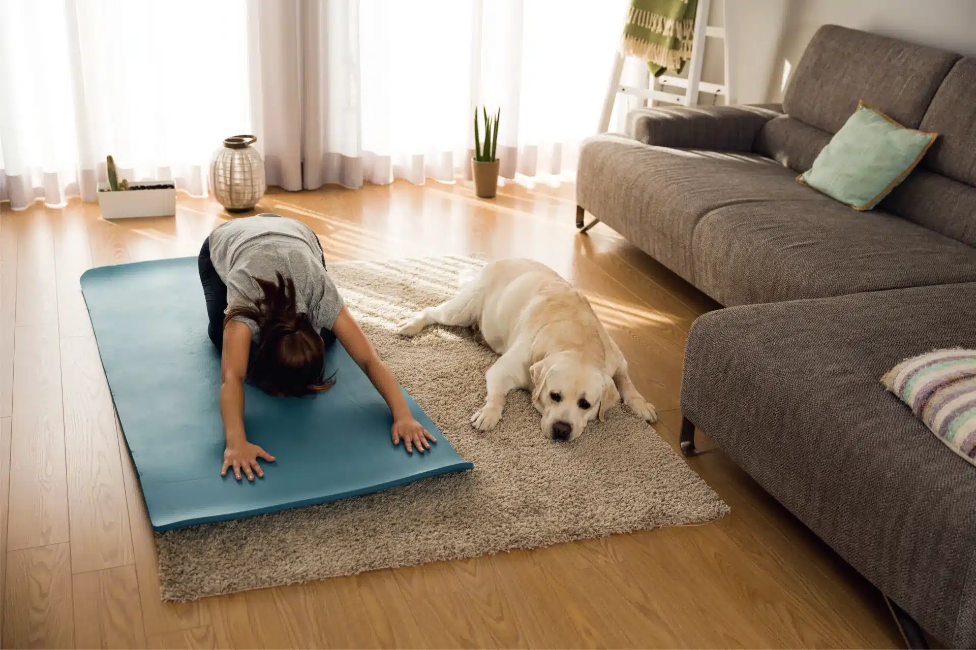 Woman exercising with llazy dog lying next to her - Physical Exercises that Can Help You Become a Better Entrepreneur