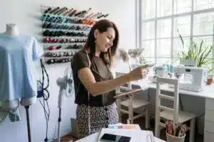 Woman runs local sewing susiness startup. What Are Local Businesses