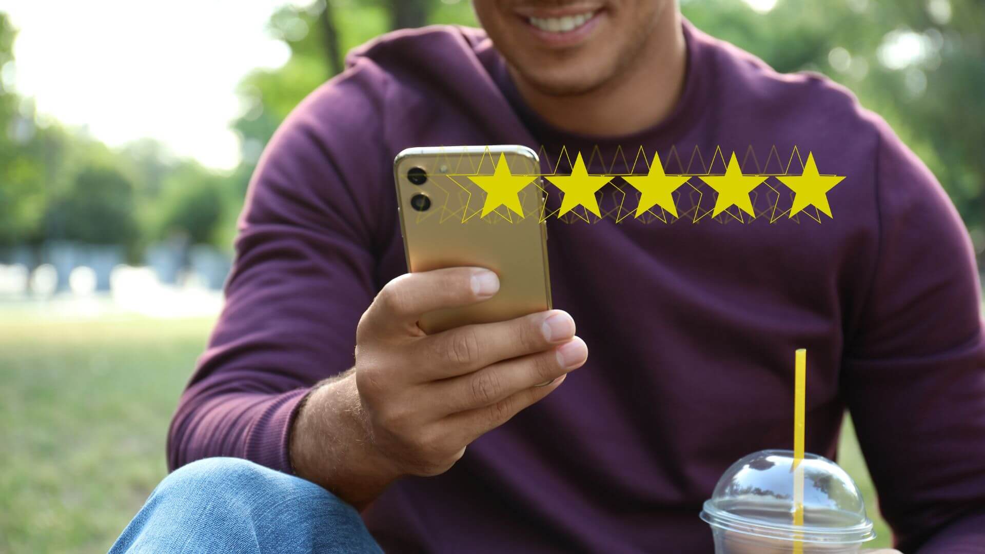 image of a man writing review using his phone